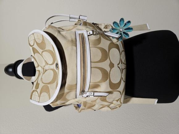 Coach Handbags - LIKE NEW Beige and White Coach Backpack purse with Blue Flower zipper pull